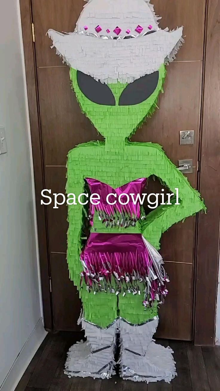 an alien is standing in front of a door wearing a purple dress and white hat