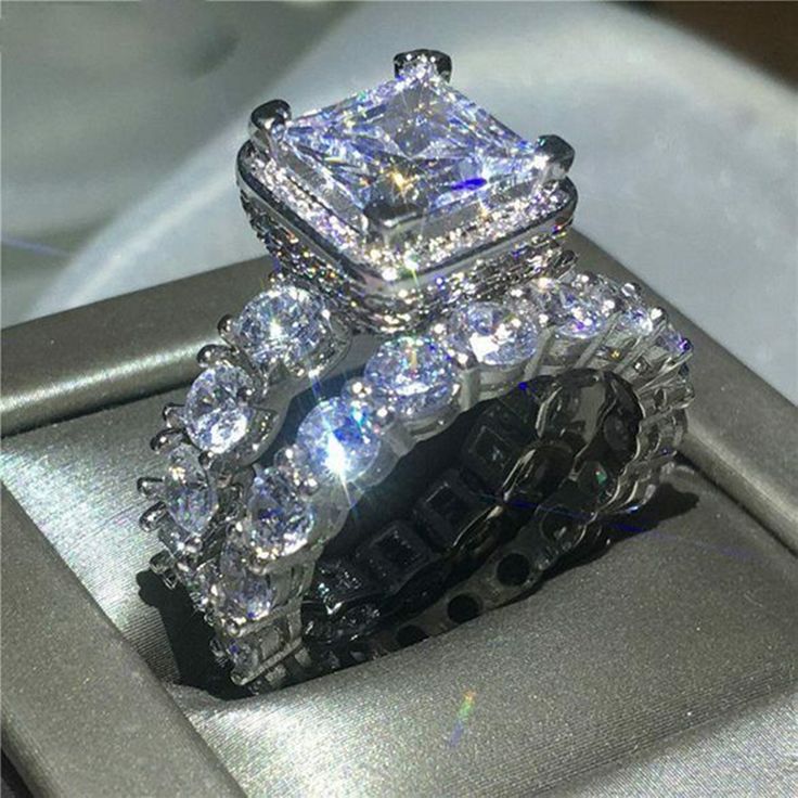 two engagement rings sitting on top of each other