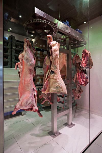 some meat hanging up in a store window