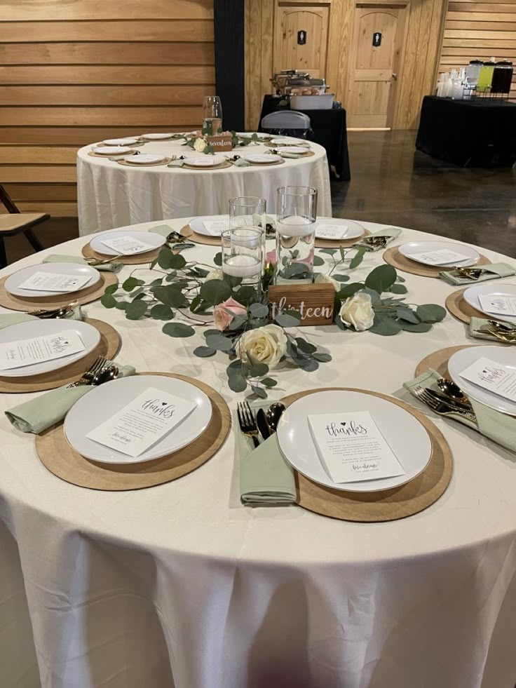 the table is set with place settings for guests to sit down and enjoy their meal