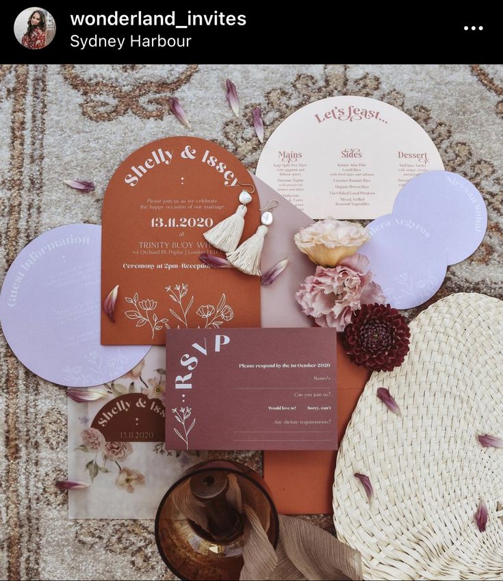 the wedding stationery is laid out on the carpet