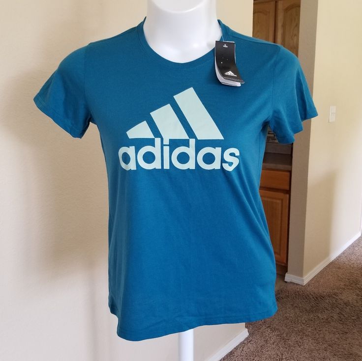 Adidas Climalite The Go-To Performance Tee Size Medium A Blue / Teal Color With A Large Classic Adidas Logo On The Front In A Lighter Pale Blue. Climalite Sweeps Sweat Away From Your Skin So You Stay Dry Every Step Of The Way. Blue Adidas T-shirt With Logo, Blue Adidas Athleisure Top, Blue Adidas Sportswear Top With Logo, Blue Adidas Sportswear Top, Blue Sports Top With Three Stripes Branding, Blue Sports Tops With Three Stripes Branding, Blue Adidas Logo T-shirt For Sportswear, Blue Adidas Tops For Sports Season, Blue Logo Print Activewear For Sports