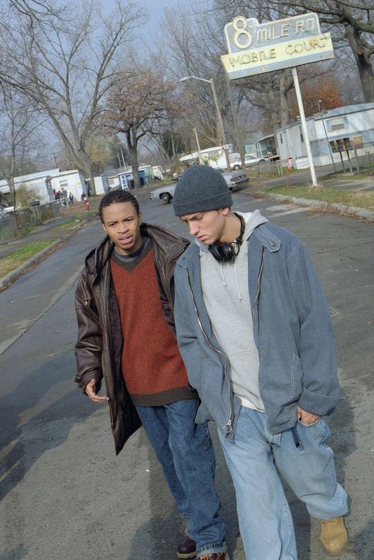 two young men are walking down the street