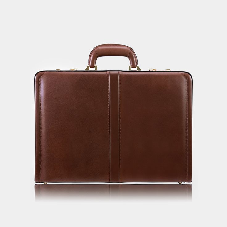 The Classic Slim Attaché Case A modern spin on the classic slim attaché case, The Reagan is designed with the modern professional in mind. *note that the current run of The Reagan in brown is a slightly darker shade than in this video. This is due to natural variation in animal hides. Please check the product photos for an accurate color. With an ultra-slim design, a 3 digit combination lock, a comfortable top carry handle, protective feet to keep it standing upright and a specially designed tab Formal Brown Briefcase With Case Included, Classic Cognac Briefcase For Formal Use, Classic Cognac Briefcase For Business, Brown Rectangular Briefcase For Formal Use, Formal Cognac Cases With Leather Lining, Elegant Cognac-colored Case For Formal Occasion, Timeless Cognac Briefcase For Formal Occasions, Elegant Cognac Case For Formal Use, Timeless Cognac Briefcase For Formal Use