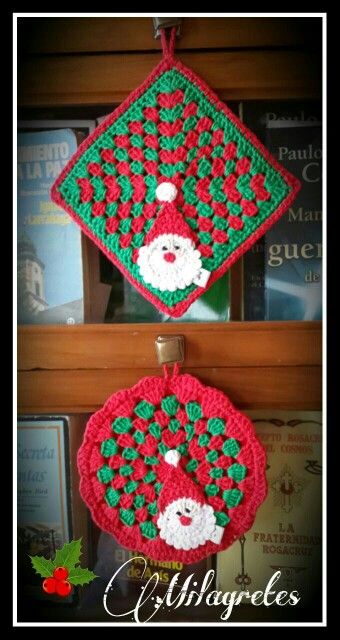 two crocheted christmas ornaments hanging from a shelf