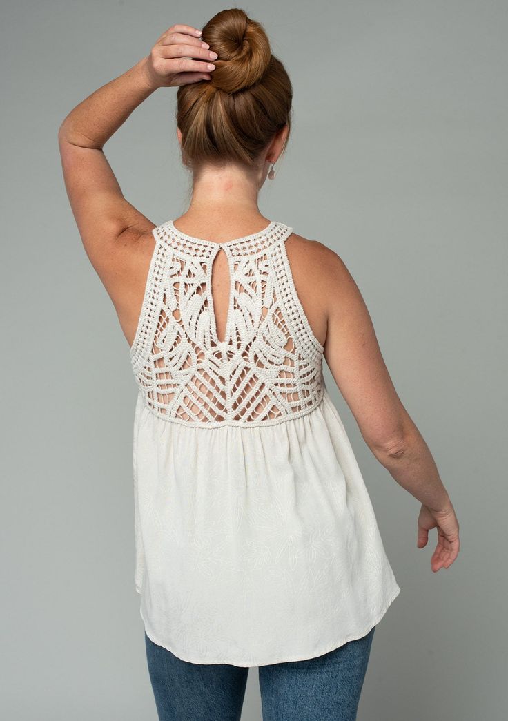 A sheer crochet-knit yoke adds a bohemian touch to this flowy tank top. Featuring a sexy racerback with a peek-a-boo keyhole detail. Perfect for festival season, we love to style this easy tank top with denim cut-offs and a simple sandal. Open knit crochet Textured floral jacquard Relaxed, flowy fit Sleeveless Crochet yoke Round neckline Racerback Back keyhole Hook & eye closure Bohemian crochet tank top Model is 5'9, wearing a size S.Style: I-13907W-RTW Bohemian Cami Top With Crochet Trim, Vacation Crochet Cami Top With Lace Trim, Lace Trim Cami Crochet Top For Vacation, Summer Sleeveless Crochet Top With Lace Trim, Sleeveless Summer Lace Top With Crochet Trim, Bohemian Flowy Tops With Crochet Trim, Bohemian Flowy Top With Crochet Trim, Flowy Bohemian Top With Crochet Trim, Summer Tank Top With Crochet Trim