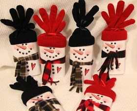 six snowman mittens and gloves on a white blanket