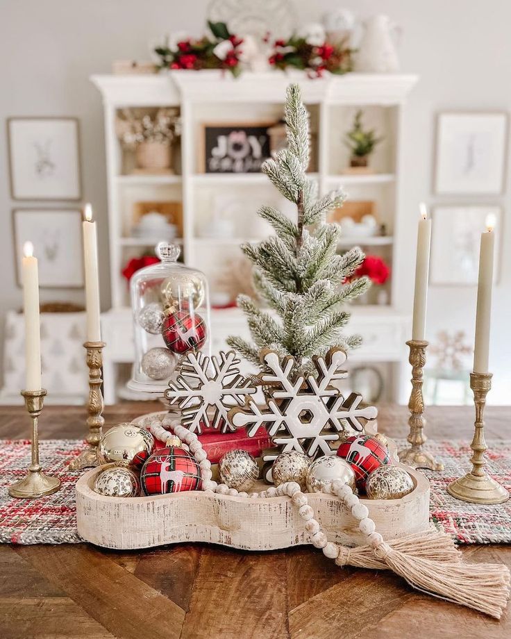 a wooden table topped with a christmas tree and other decorating items on top of it