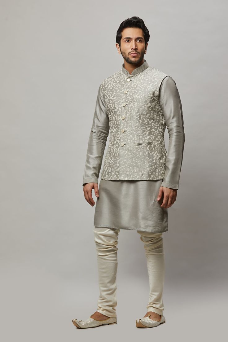 Cotton Linen blended kurta with floral ivory thread & gold sequence intertwined embroidered vest plus ivory churidar. The cotton-linen blend makes it one of our lightest and most breathable kurtas. Crafted with a collar neckline, full sleeves, and front button closure. Occasion: Can be worn to events like Sangeet, Mehendi, & Wedding WASH CARE INSTRUCTIONS - Please Dry clean only when it is applicable. Slight color variation is possible due to digital photography. Designer Sleeveless Raw Silk Kurta, Cotton Silk Nehru Jacket With Floral Embroidery For Diwali, Spring Cotton Silk Nehru Jacket With Chikankari Embroidery, Spring Nehru Jacket With Chikankari Embroidery In Cotton Silk, Eid Floral Embroidered Raw Silk Nehru Jacket, Spring Designer Cotton Silk Nehru Jacket, Spring Wedding Chanderi Bandhgala, Spring Wedding Bandhgala In Chanderi, Cotton Silk Nehru Jacket With Floral Embroidery For Eid