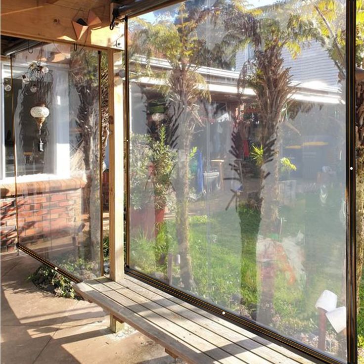 the sun is shining through the glass on this house's front porch and garden area