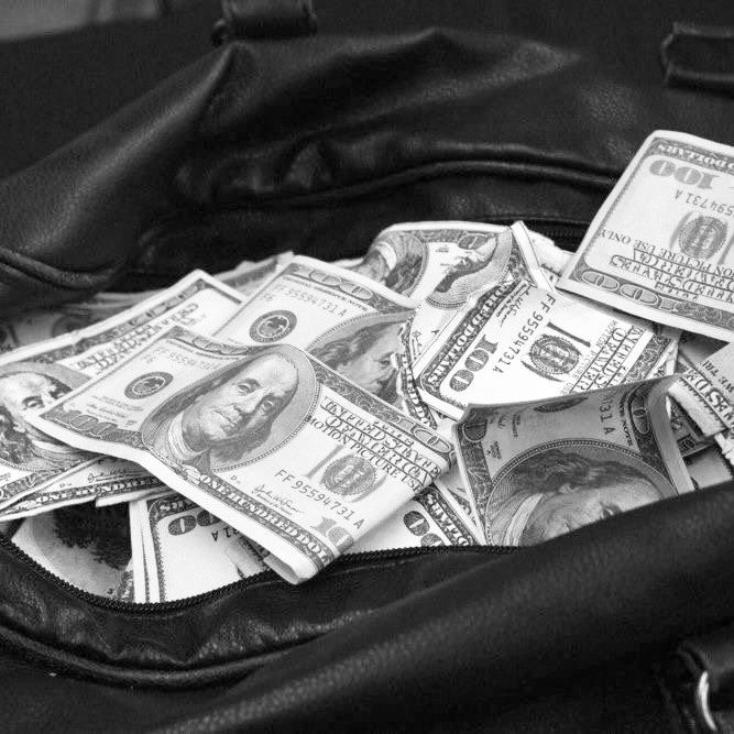 black and white photograph of money in a purse