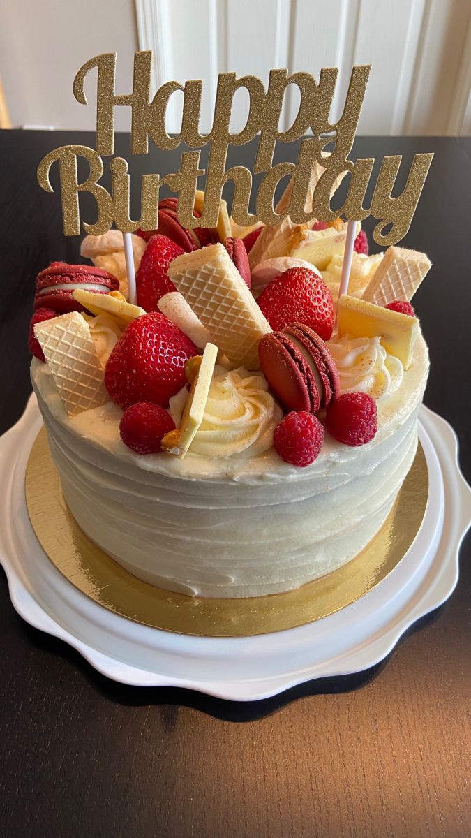 a birthday cake with strawberries and ice cream