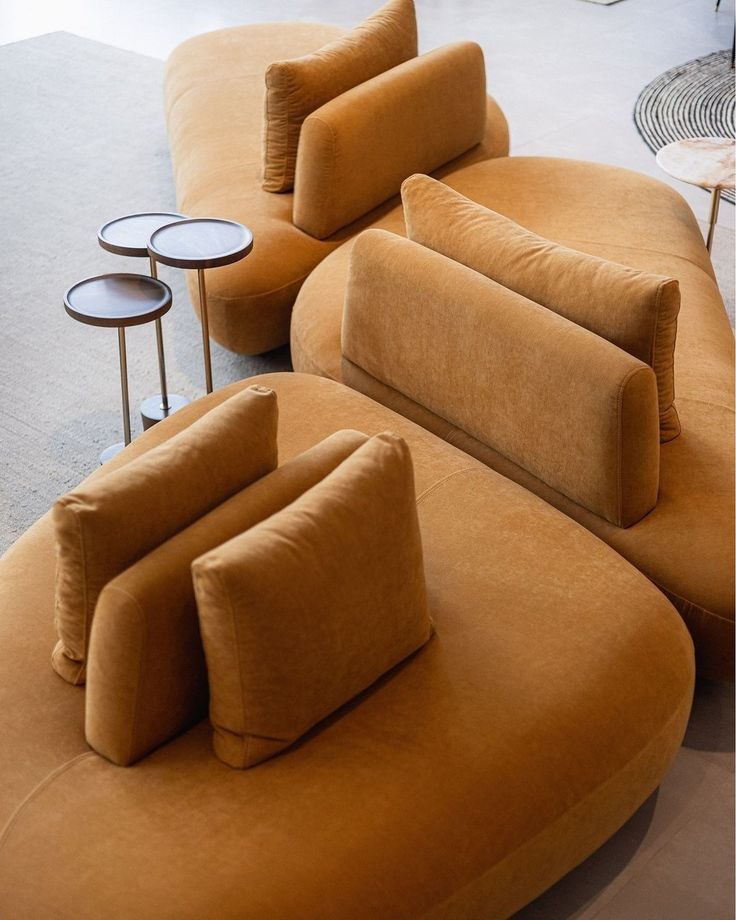 an orange couch and two tables in a room