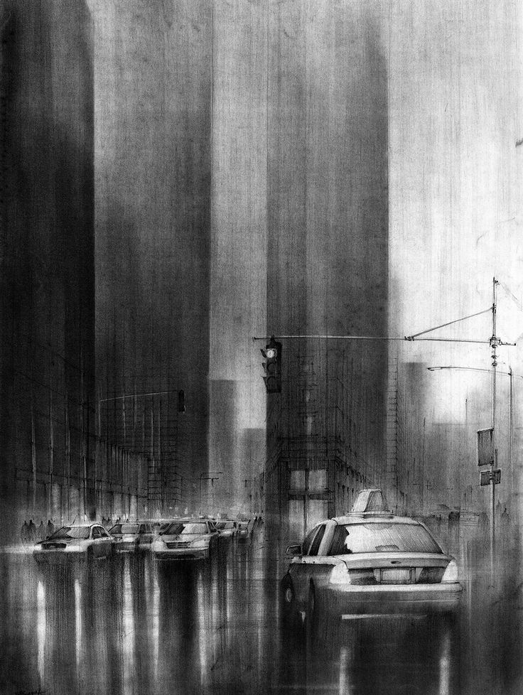 a black and white photo of a city street with cars driving down the road in front of tall buildings