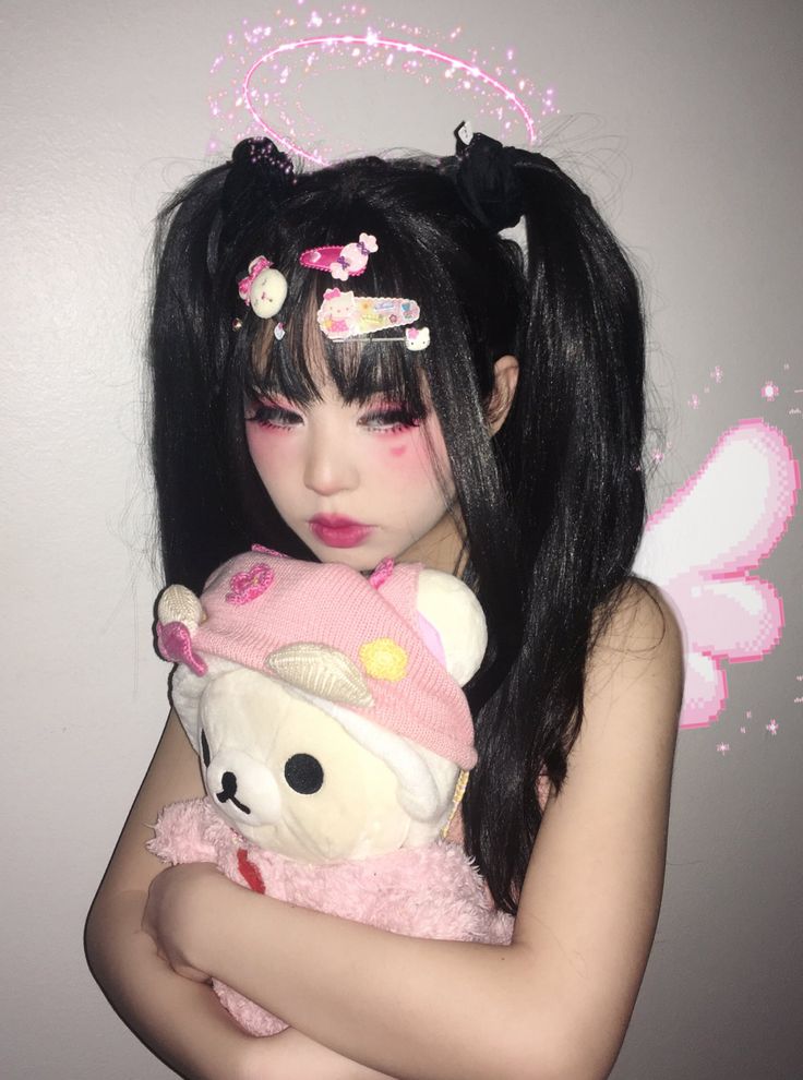 a girl with long black hair holding a teddy bear