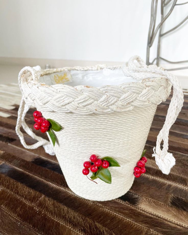 "Sweetest bucket bag ever! Pristine white rope bucket bag with beautiful red cherries peppered on the front. This is such a lovely summer bag. Fits tonnes. Condition: Very good. Some loss of white paint on the trim but not obvious when carried. The lining seems a little \"rough\" around the seams but again, doesn't detract from how lovely this baby is. Label: K& G Charlet Measurements: Top side to side 9\" Bottom side to side 5\" Top to bottom (excluding handle) 8.5\" Handle drop 12\" This item White Handmade Bucket Beach Bag, Bucket Beach Bag, Handmade White Bucket Bag For Vacation, White Handmade Bucket Shoulder Bag, Handmade White Basket Shoulder Bag, White Bucket Bag As A Gift, Red Bucket Bag For Beach, Red Bucket Bag For The Beach, White Basket Bucket Bag With Braided Handles