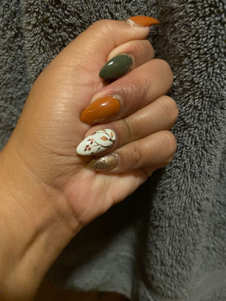 Burnt Orange And Sage Green Nails, Green Orange And Gold Nails, Dark Green And Brown Nails, Fall Almond Nails Ideas Green, Brown Leaf Nails, Green And Brown Fall Nails, Olive Green And Orange Nails, Green Orange Brown Nails, Fall Nails Green And Orange