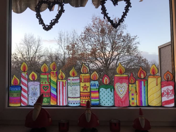 a window decorated with candles and hearts