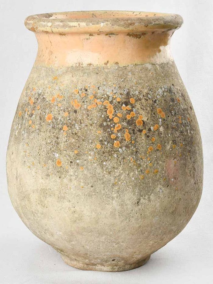 an old vase with orange speckles on it