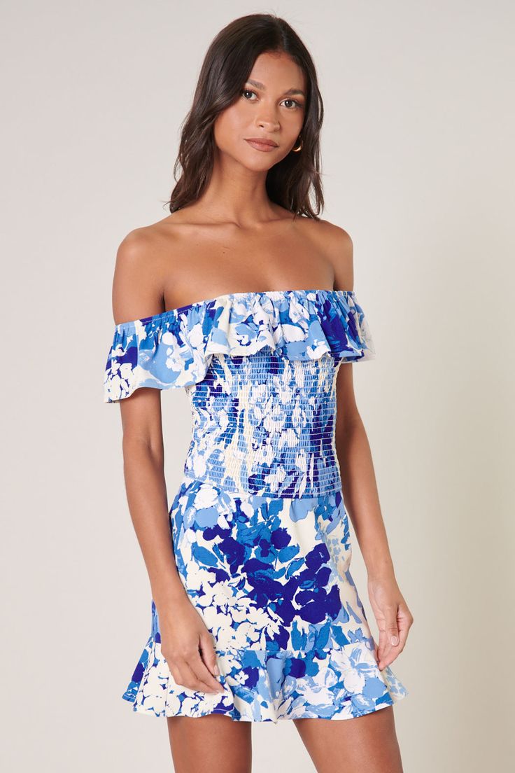 Cool like the sea, this blue abstract floral print embodies the perfect top for a warm day out to brunch. It features an off the shoulder design with a ruffle detail that sweeps from shoulder to shoulder. The bodice is fully smocked to create a flattering fit that ends right at the hips. Wear it with bottoms of your choice or complete the coord set with the matching skirt.- Smocked- Off the shoulder- Ruffle detail- Color: White BlueSize + Fit - Model is 5'9" and wearing size XS- Measurements tak Off-shoulder Smocked Top With Ruffles For Vacation, Summer Floral Print Smocked Top For Brunch, Blue Off-shoulder Floral Print Tops, Blue Off-shoulder Top With Floral Print, Off-shoulder Summer Smocked Top For Day Out, Off-shoulder Beach Top With Smocked Back, Off-shoulder Tops With Smocked Back For Beach, Summer Off-shoulder Smocked Top With Ruffles, Summer Off-shoulder Smocked Top For Beach