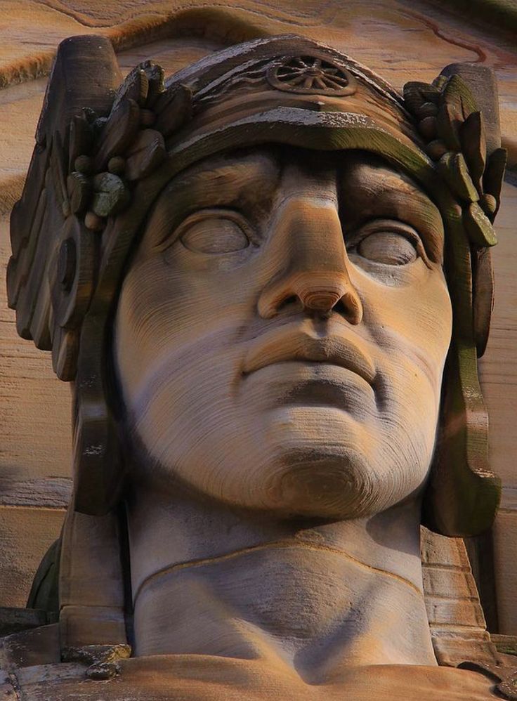 a close up view of the face and head of a statue