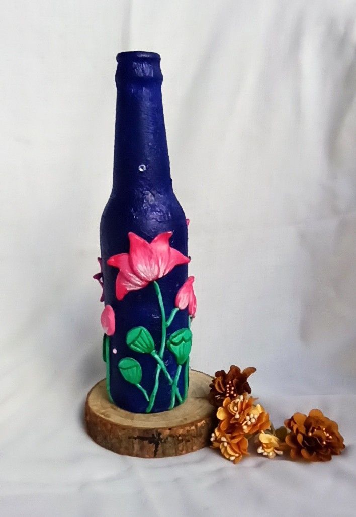 a blue bottle with flowers painted on it