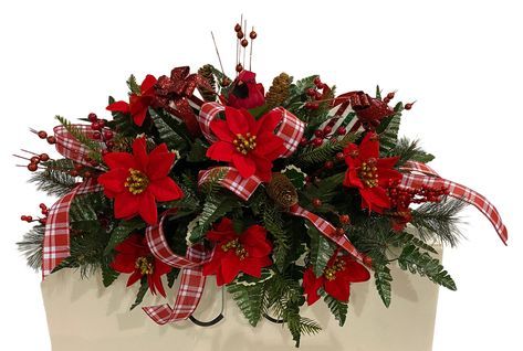 a christmas planter with red poinsettis and greenery in a white box