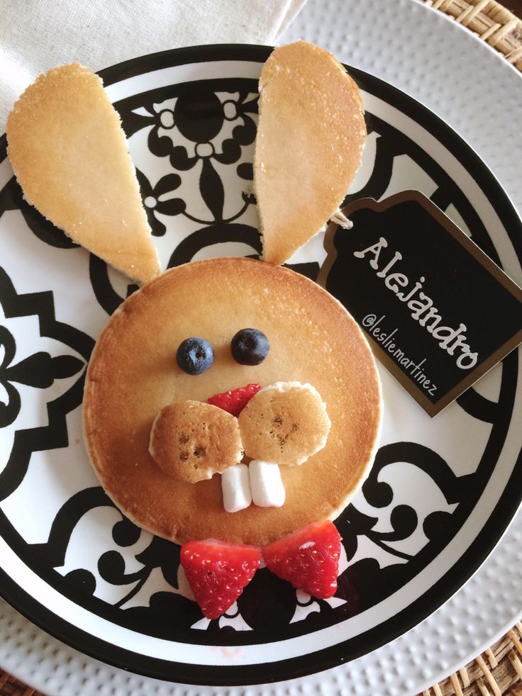 a plate topped with pancakes covered in icing and bunny ears on top of it