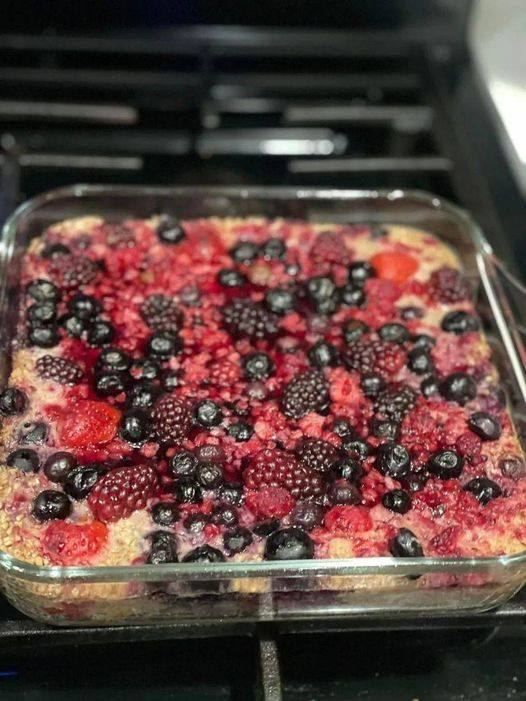 a casserole dish with berries and blueberries in it sitting on the stove