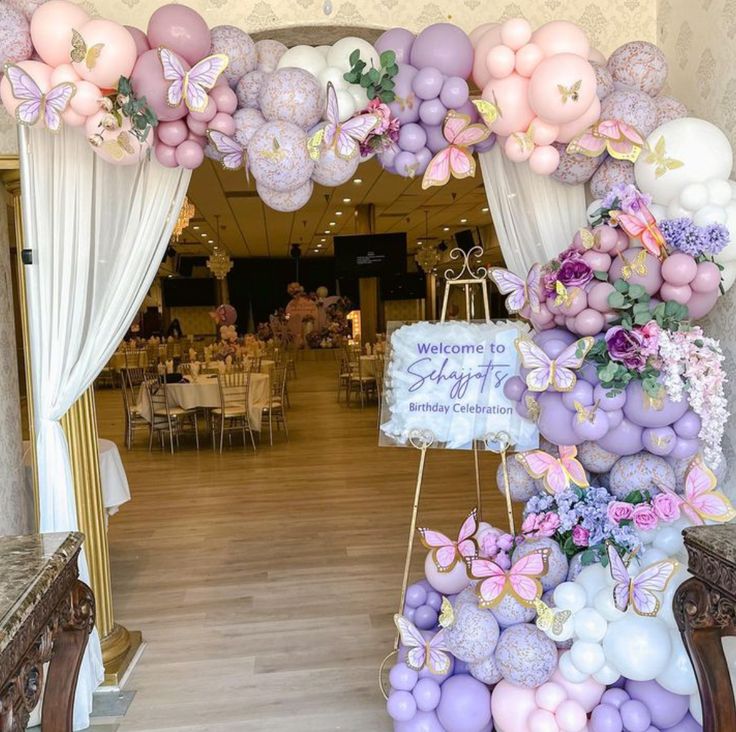 an entrance decorated with balloons and flowers for a wedding or baby shower party at the reception hall