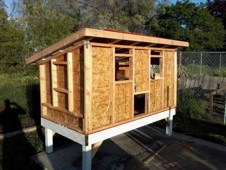 a small wooden structure sitting in the middle of a yard