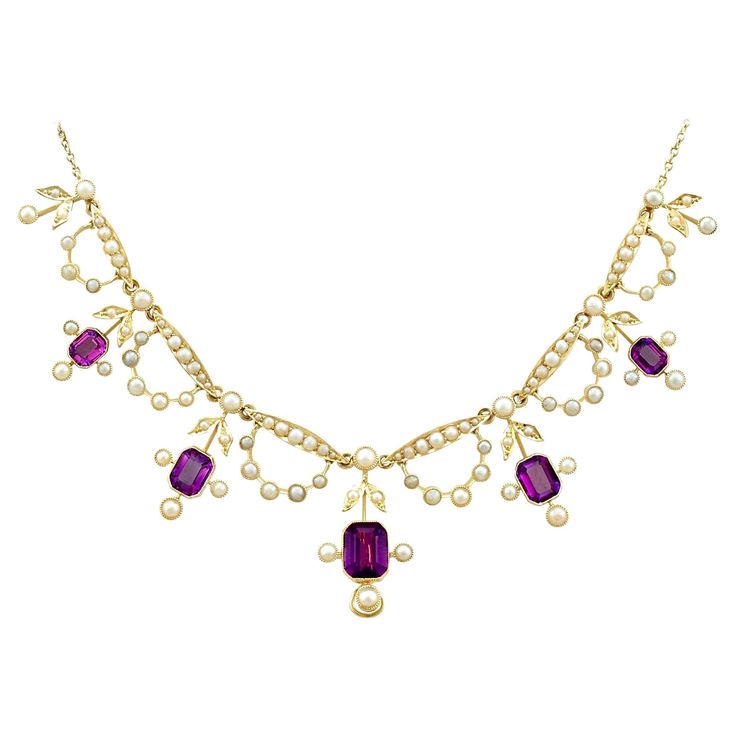 A stunning antique Edwardian 4.47 carat amethyst and seed pearl, 15 karat yellow gold necklace; part of our diverse antique jewellery and estate jewelry collections. This stunning, fine and impressive antique Edwardian amethyst necklace has been crafted in 15k yellow gold. The feature setting is ornamented with five floriated drop settings, each displaying a collet set emerald cut amethyst, totalling 4.47cts. Each amethyst setting incorporates three protruding collet set pearls, in addition to a Edwardian Necklace, Seed Necklace, Amethyst Set, Edwardian Jewelry, Diamond Necklace Set, Yellow Gold Necklace, Antique Necklace, Victorian Jewelry, Seed Pearl