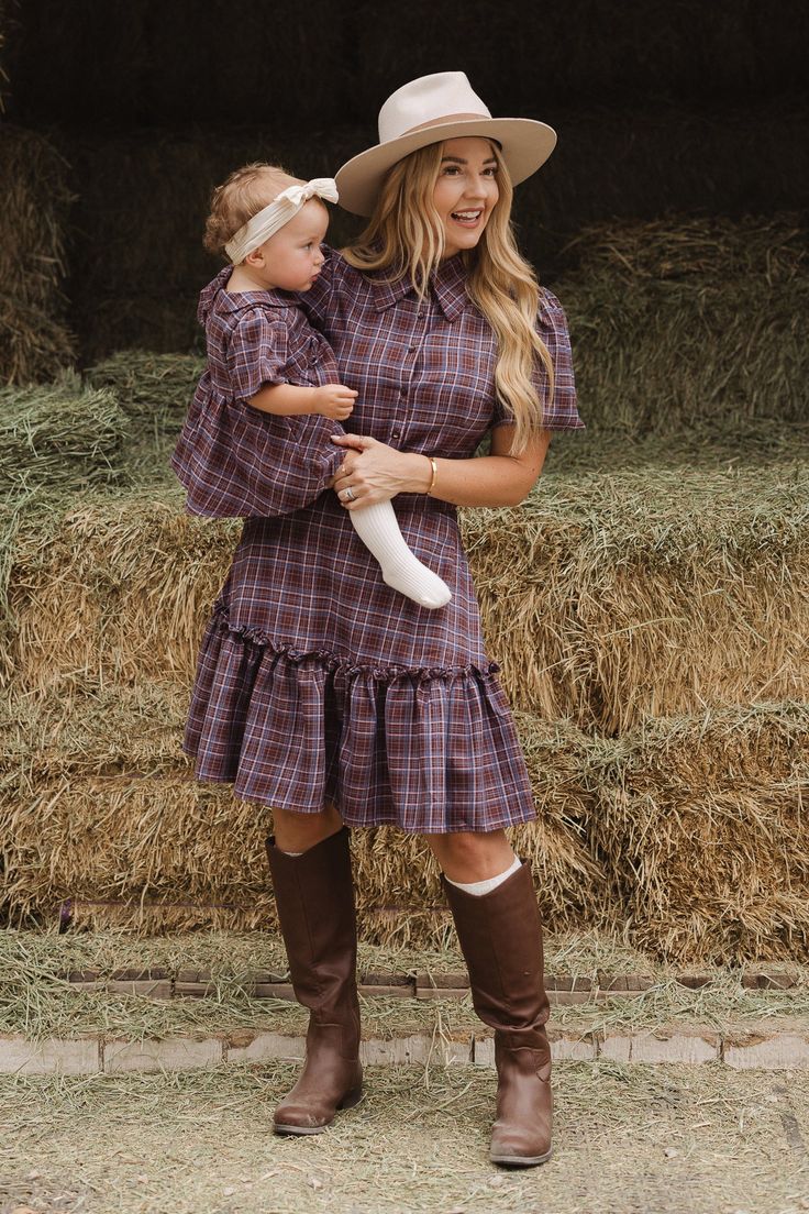 Your new favorite fall dress is here! Say hello to the Virginia Dress in Plaid! Made with soft 100% cotton fabric, and features a v-neckline with a classy collar, and short puff sleeves with an elastic closure. The knee-length skirt has a playful ruffle hem and practical pockets. Plus, the pull-over style with functional buttons make it nursing friendly. This women's dress proves you never have to sacrifice comfort for style. Perfect for family matching. Long Beige Coat, Photography Outfits, Market Display, Craft Market, Fall Photography, Fall Wardrobe Essentials, City Woman, Beige Coat, Leather Jacket Style