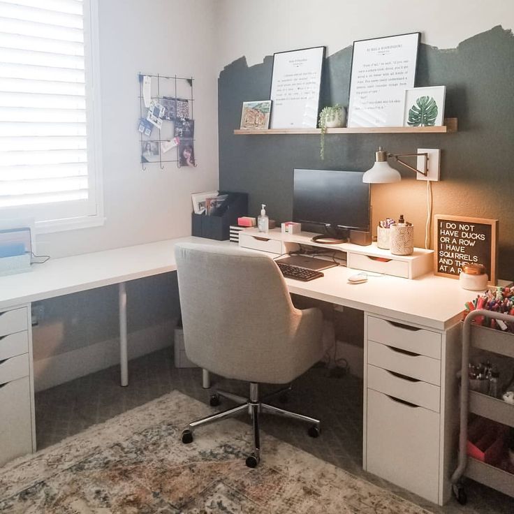 a home office with white furniture and lots of drawers