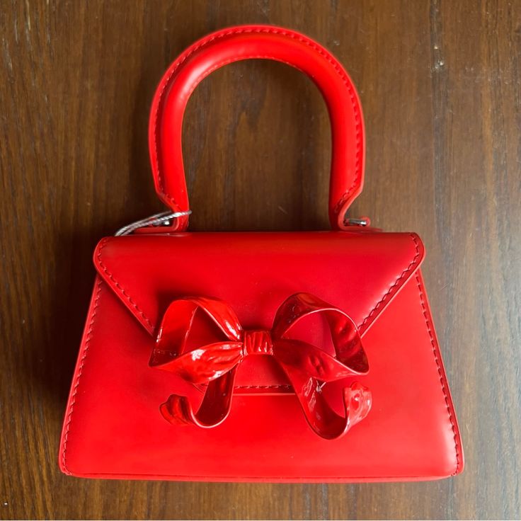 From Self-Portrait, Mini Top Handle Bag In Smooth Red Leather With Metal Bow Detail. Includes Shoulder Strap, Dust Bag, And Box. New And Never Used. H: 3.5” (7” With Handle) L: 5.5” At Base W: 2” At Base Red Clutch Evening Bag For Shopping, Red Satchel Evening Bag For Party, Red Clutch Evening Bag With Detachable Strap, Chic Red Clutch Shoulder Bag, Red Evening Shoulder Bag With Detachable Strap, Red Shoulder Evening Bag, Formal Red Rectangular Shoulder Bag, Red Clutch Evening Bag With Removable Pouch, Red Shoulder Bag With Detachable Handle For Evening