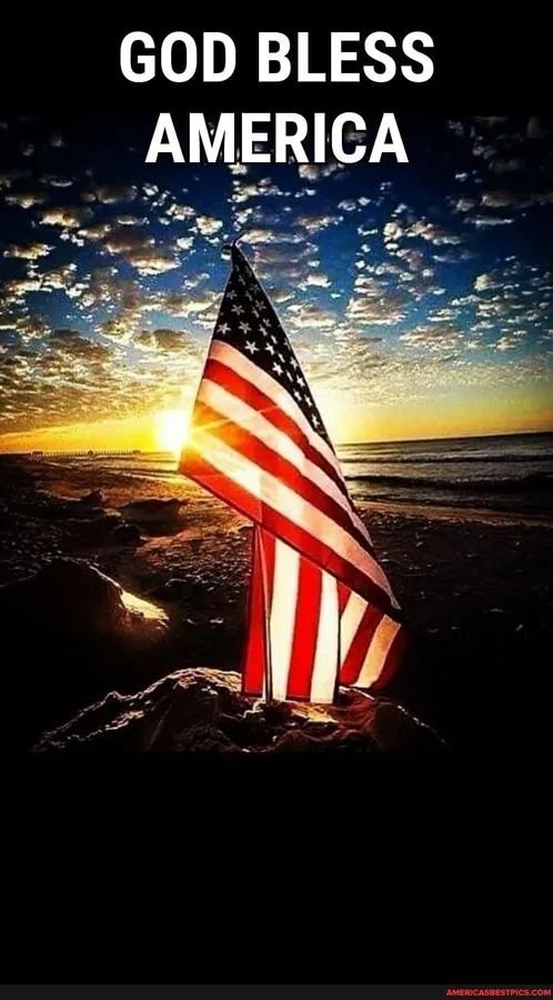 an american flag on top of a rock with the sun setting in the background and god blessing america written across it