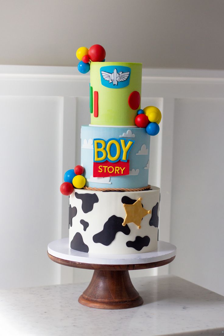 a three tiered cake with toy story on top