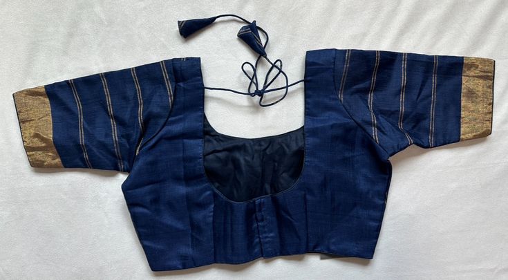 Navy blue silk blouse with lines Navy Blue Silk Blouse Designs, Blue Silk Blouse Designs, Blue Long Sleeve Silk Top, Blue Padded Blouse For Work, Blue Silk Long Sleeve Blouse, Blue Silk Long Sleeve Top, Elegant Blue Blouse For Office, Blue Fitted Cotton Blouse, Blue Cotton Office Blouse