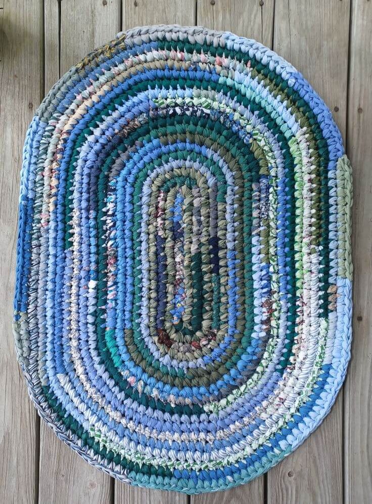 a multicolored rug on a wooden floor with wood planks in the background