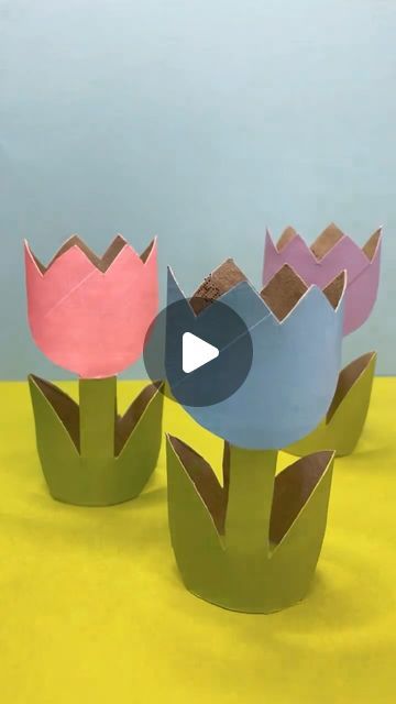 three paper flowers sitting on top of each other