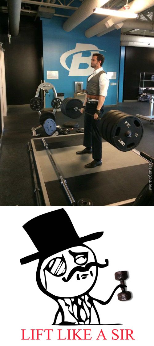 a man with a top hat standing in front of a barbell