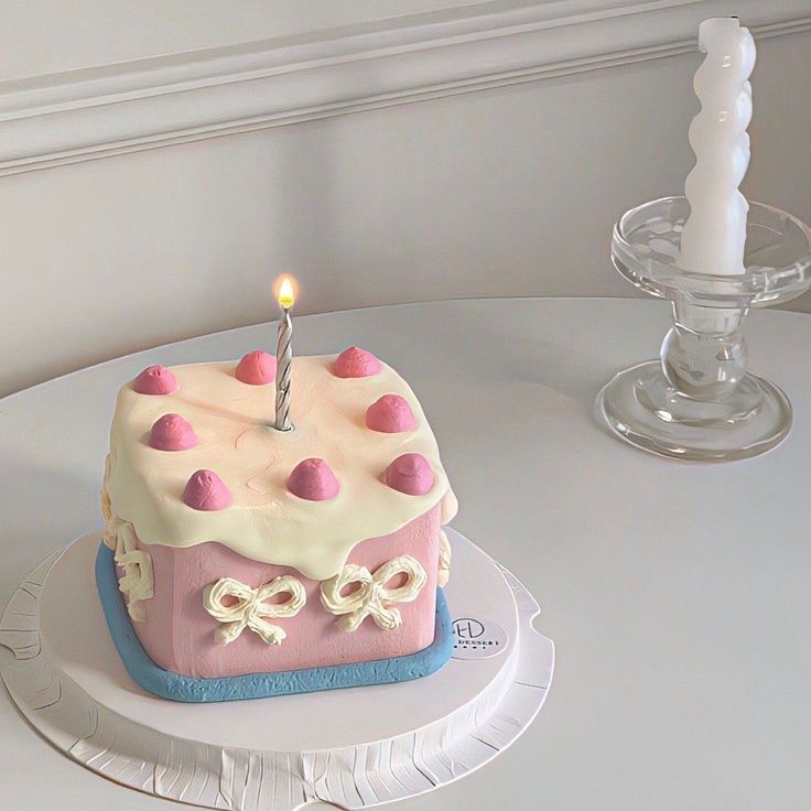 a birthday cake with a single candle on top