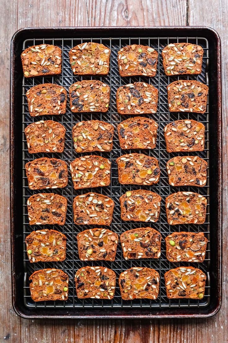 an overhead view of some baked goods on a baking rack with nuts and other ingredients