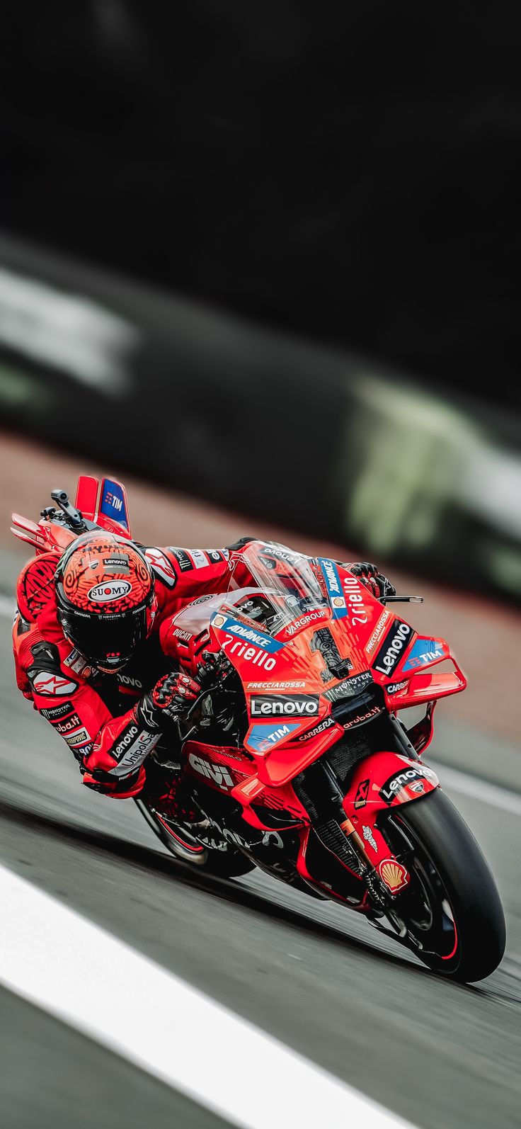 a person riding a motorcycle on a race track