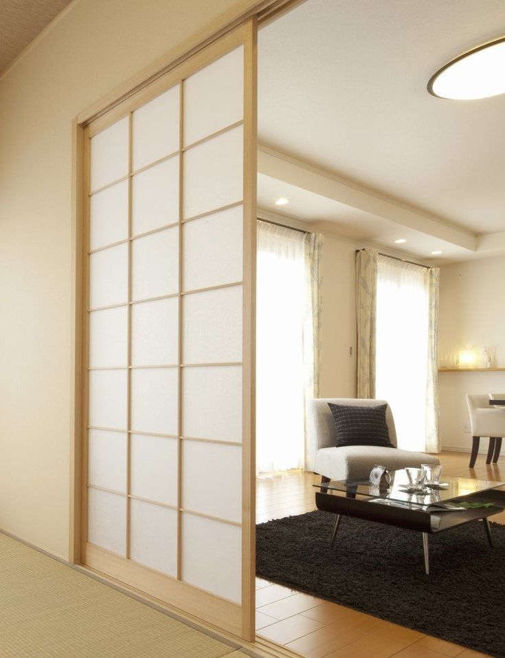 a living room filled with furniture and a sliding glass door