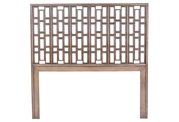 the headboard is made from wood and has an intricate design on it's sides