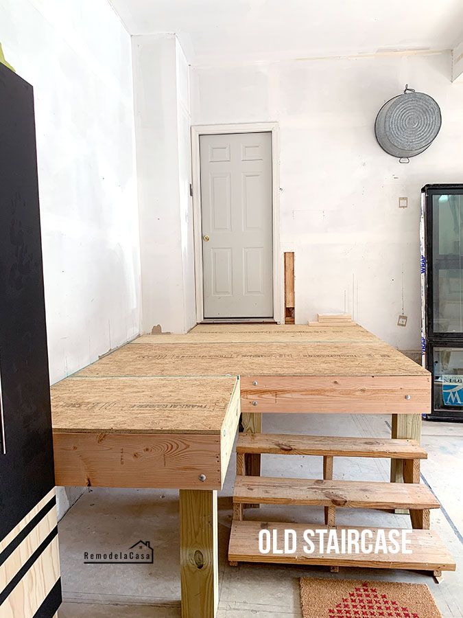 a table and benches in an unfinished room