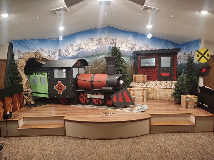 there is a fake train on the stage for children to play in it's room