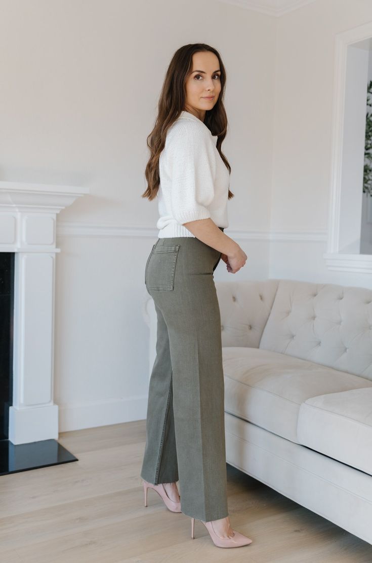 The Olive Green Wide Leg Jeans are an essential addition to any wardrobe. These classic jeans feature a flattering high waist, wide leg fit, and cropped style that flatters your figure and ensures comfort and flexibility throughout the day. Perfect for all seasons, these jeans provide timeless elegance and style. olive green wide leg pants high waist comfort stretch raw hem 98% cotton 2% spandex machine wash cold model is wearing a small SIZING CHART FOR THE JEANS: Small: fits sizing 25-26 Mediu Classic High Rise Wide Leg Pants, Classic High Waist Wide Leg Pants With Five Pockets, Classic Flare Full Length Jeans For Work, Classic Full-length Flare Jeans For Work, Classic Full Length Flare Jeans For Work, Wide Leg Bottoms For Business Casual In Fall, Business Casual Wide Leg Bottoms For Fall, Versatile Full Length Flare Jeans For Fall, Classic High Rise Wide Leg Pants With Relaxed Fit