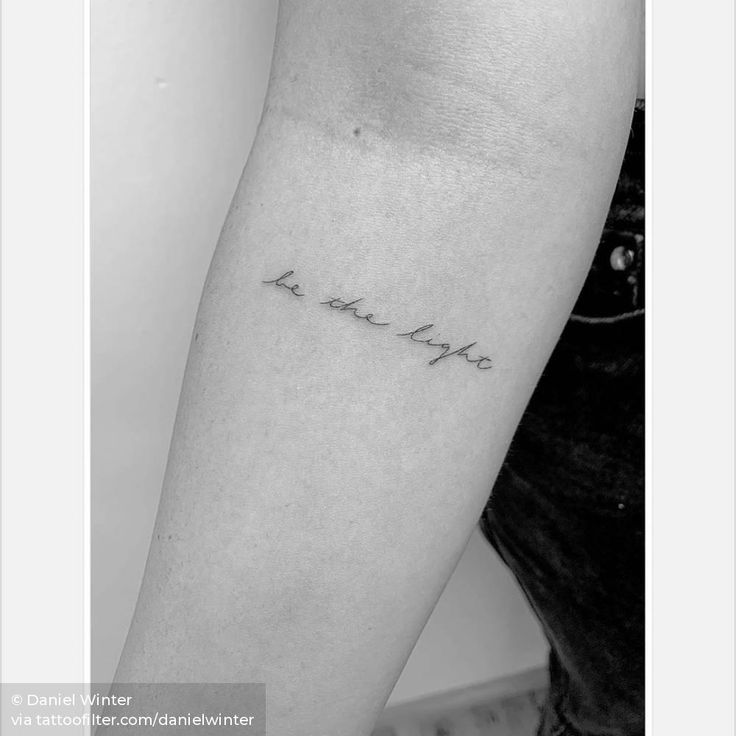 a black and white photo of a woman's arm with the word love on it